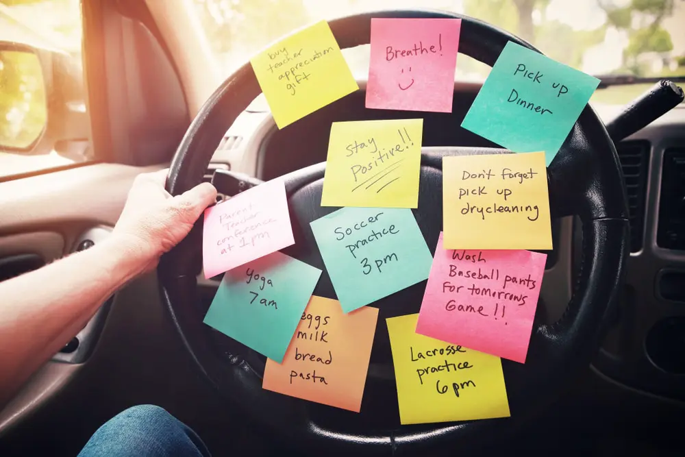 Image of post-it notes on car wheel, busy mom dealing with mom guilt