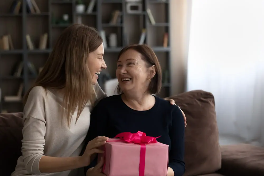 Image of a mother receiving mother's day gifts from daughter