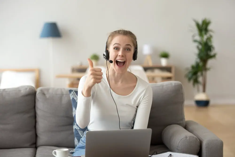 Image of a woman with headset working in a call centre job from home, one of the best stay at home jobs for moms