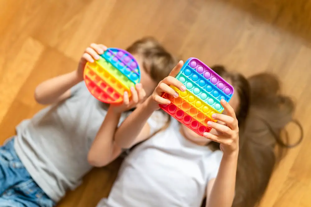 Image of children playing with popping toy to regulate, children's mental health